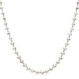 Silver necklace with small beads on a white background
