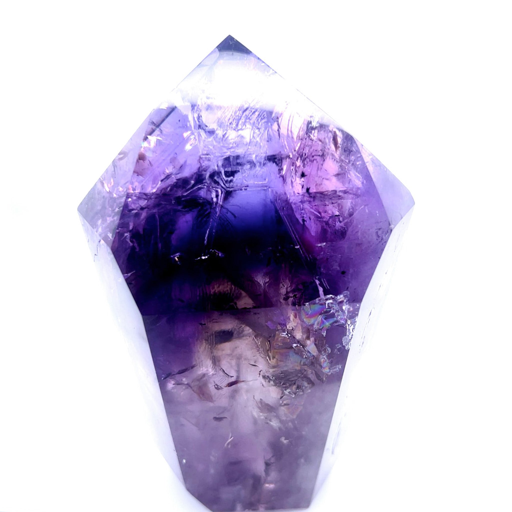 A natural amethyst crystal point with rich purple and violet tones, showing internal crystalline structures and facets, isolated on a white background.