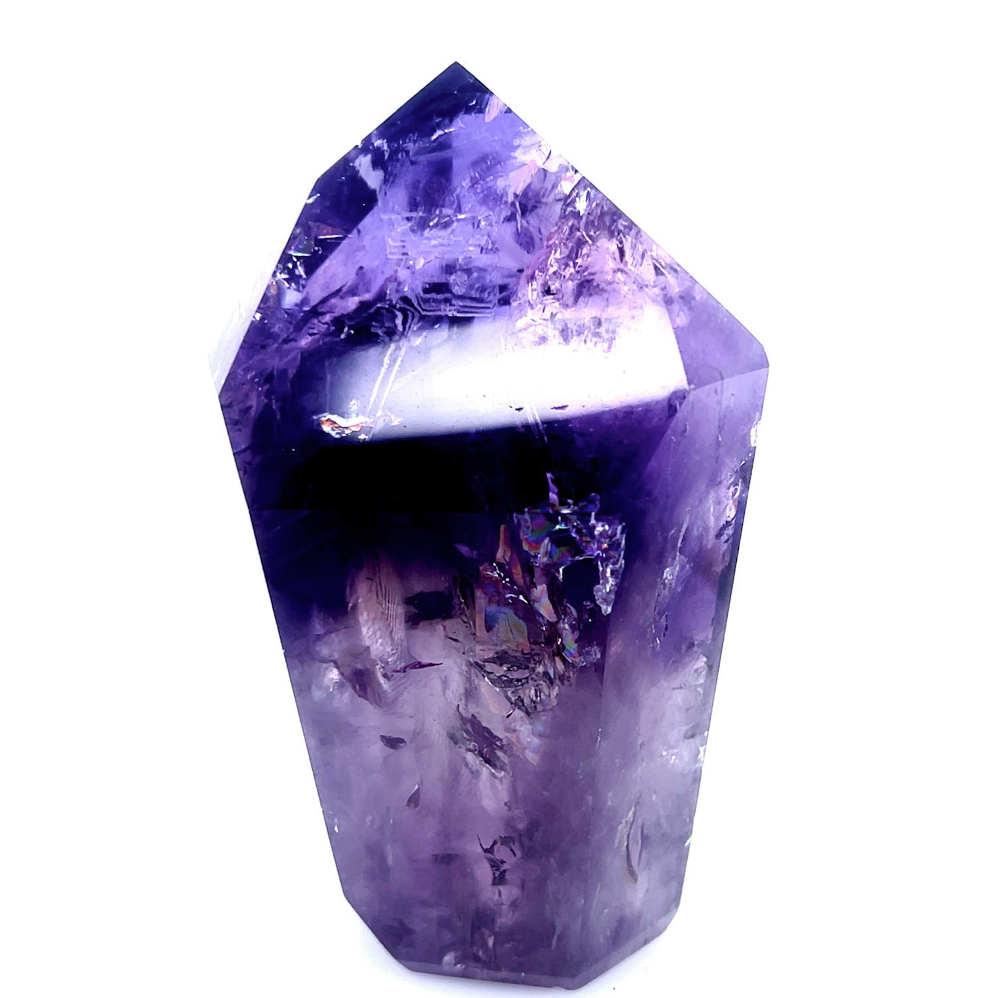 A natural purple amethyst crystal point tumbled into a polished geometric shape, shown against a solid white background.