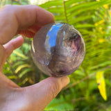 Natural purple Amethyst sphere with phantom formations in natural light