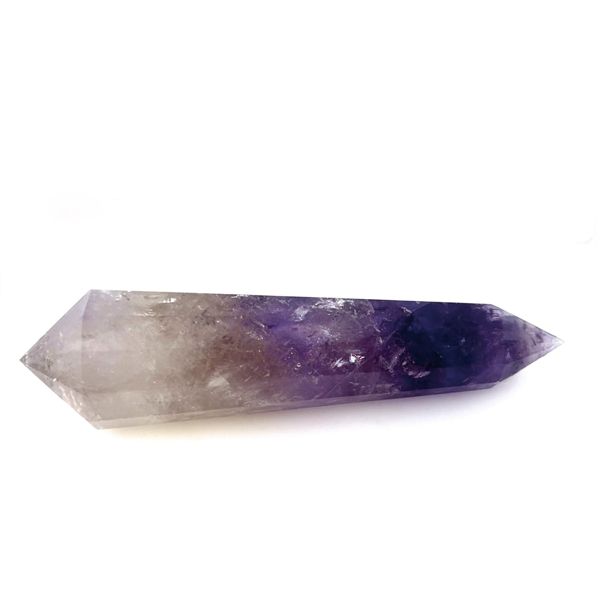 A natural amethyst crystal point with a smooth gradient from light gray at the top to deep purple at the bottom, photographed on a clean white background.