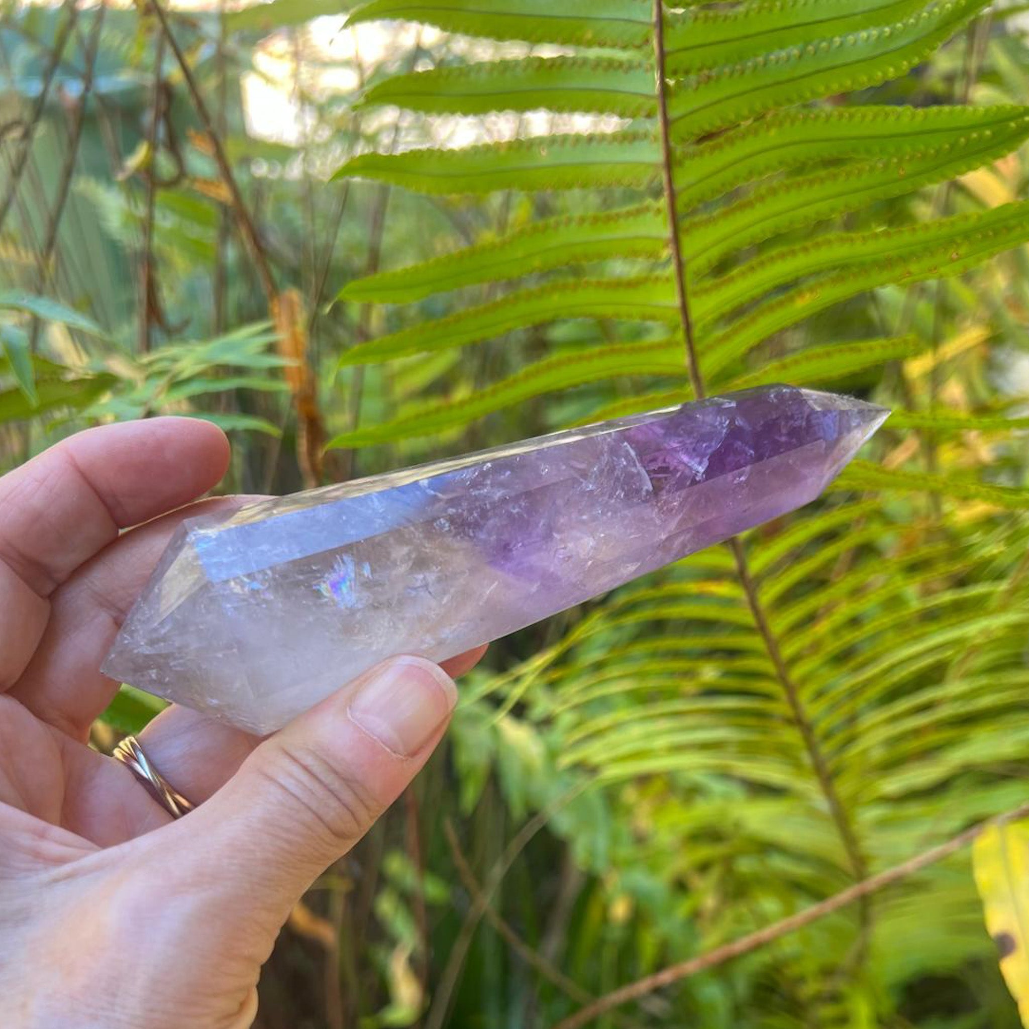 Hand-held Amethyst Smoky Quartz Vogel showing scale