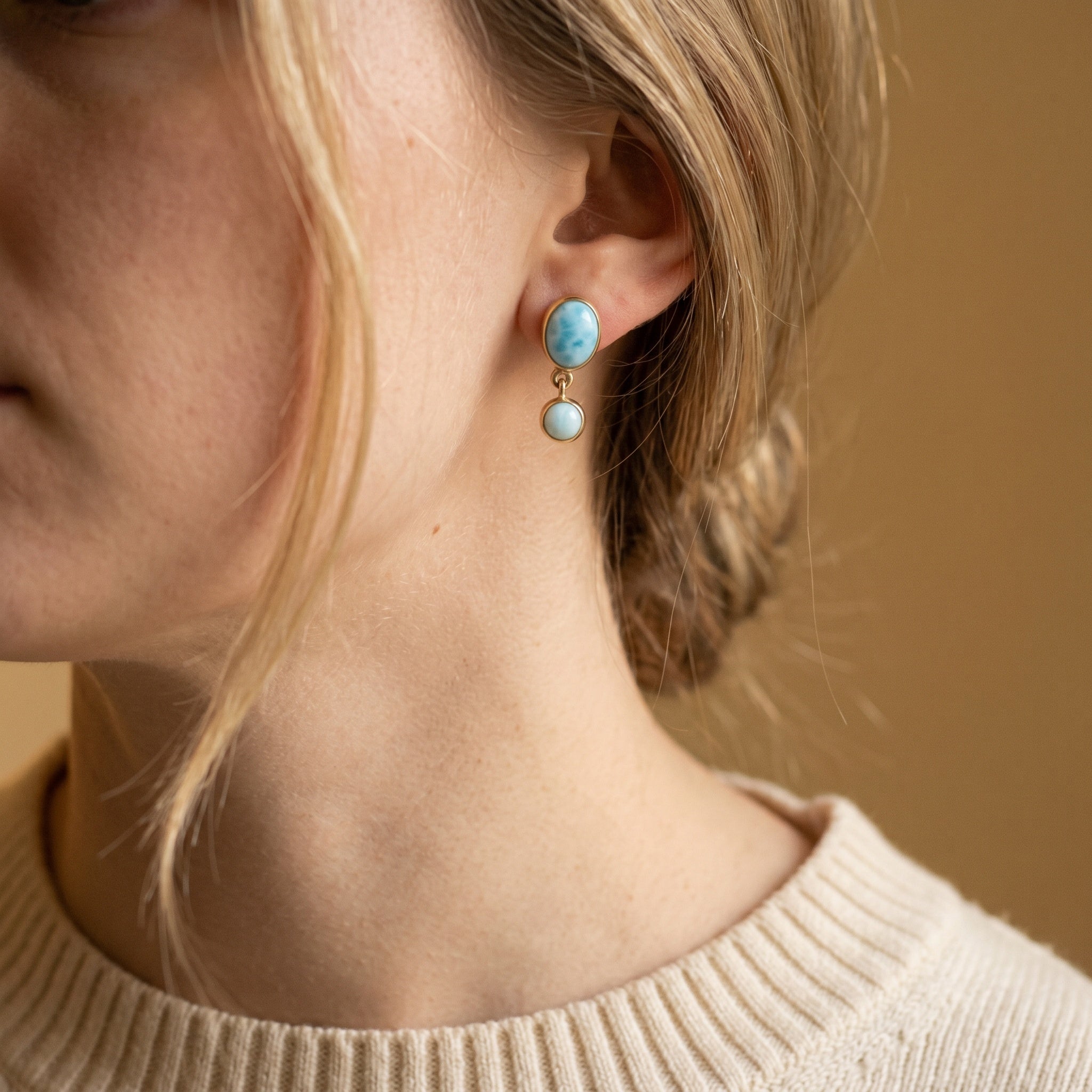 Larimar 18k gold plated double drop earrings on a model for size reference