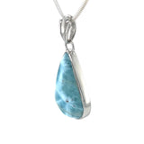 Side view of Larimar silver pendant showing polished blue gemstone and setting