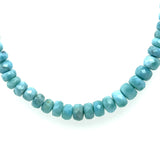 Close up of Larimar rondelle beads showing Caribbean-blue colour and patterning