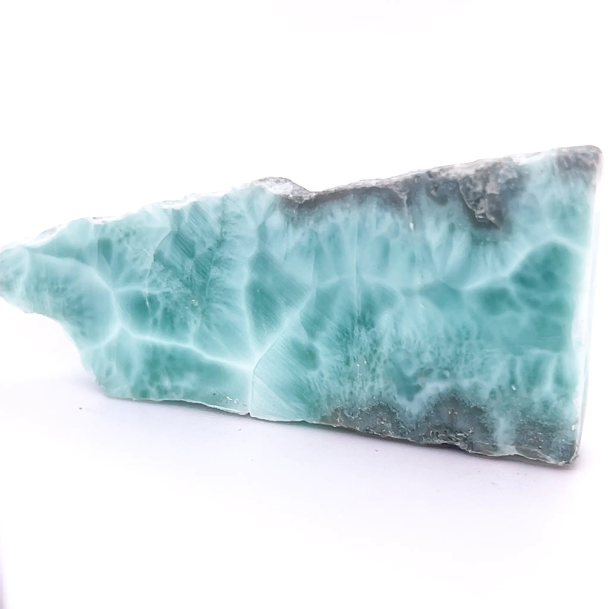 Natural blue Larimar slice with white web-like patterning and polished face