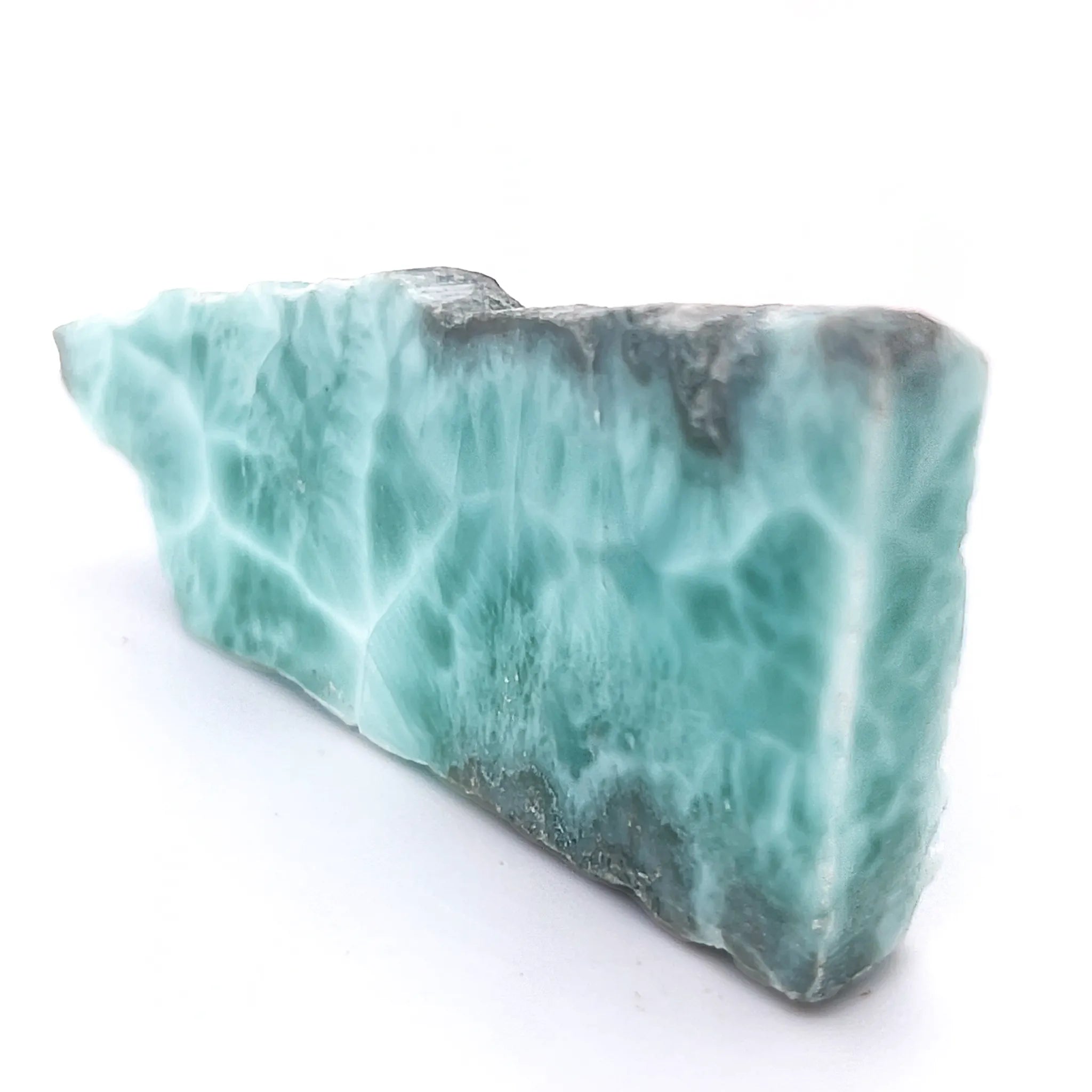 Natural Dominican Republic Larimar slice with polished blue face and rough edge