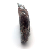 Side view of Larimar specimen showing volcanic host rock and polished blue stone