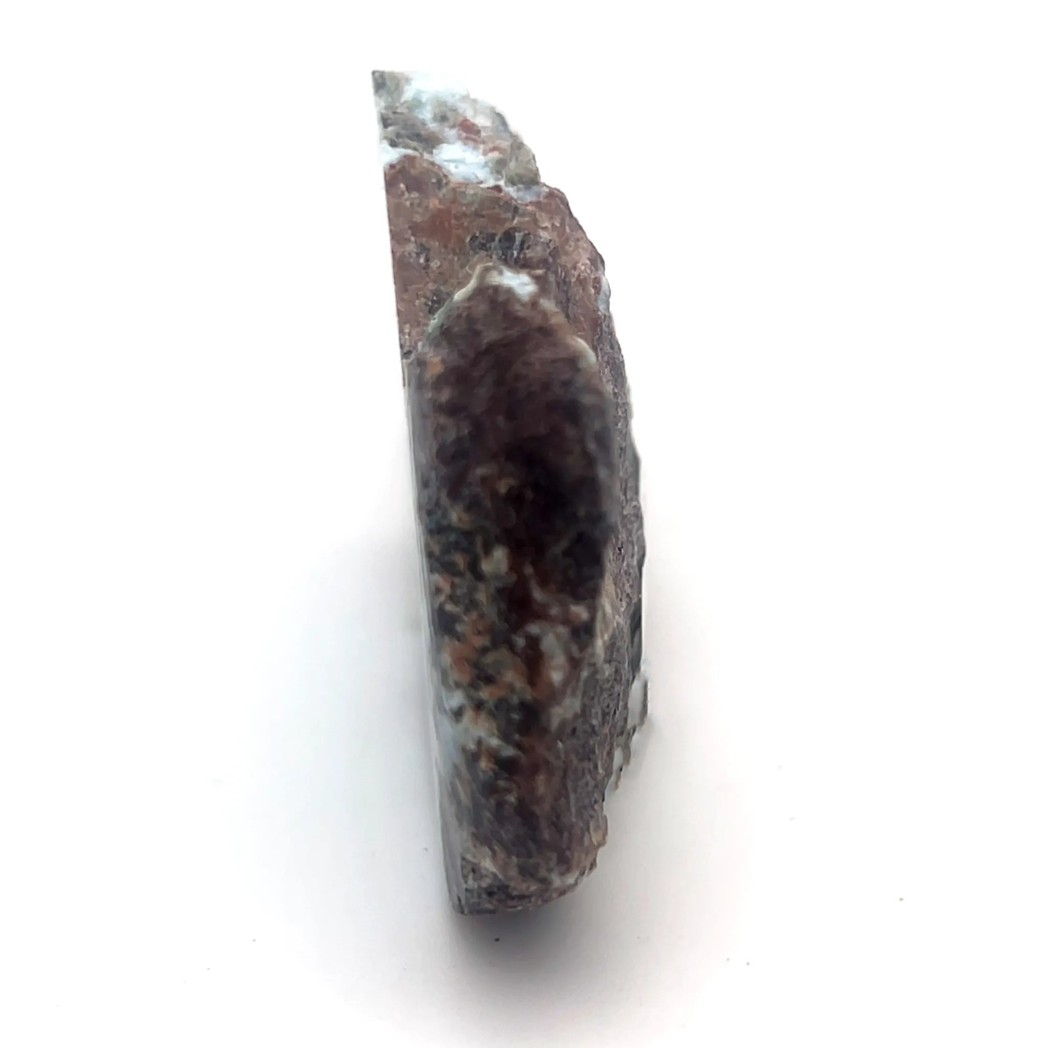 Side view of Larimar specimen showing volcanic host rock and polished blue stone