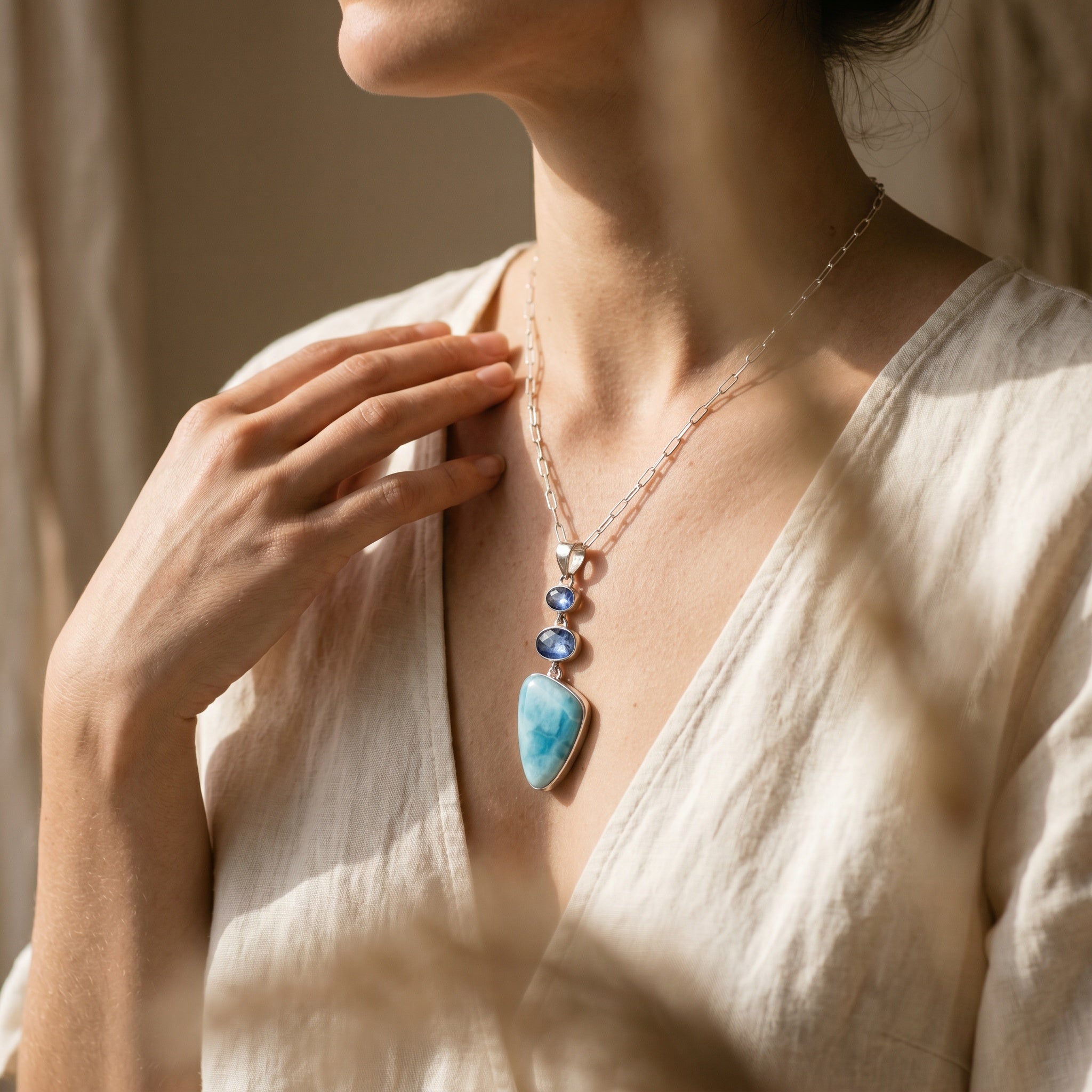 Larimar and Blue Kyanite silver pendant worn on model for scale