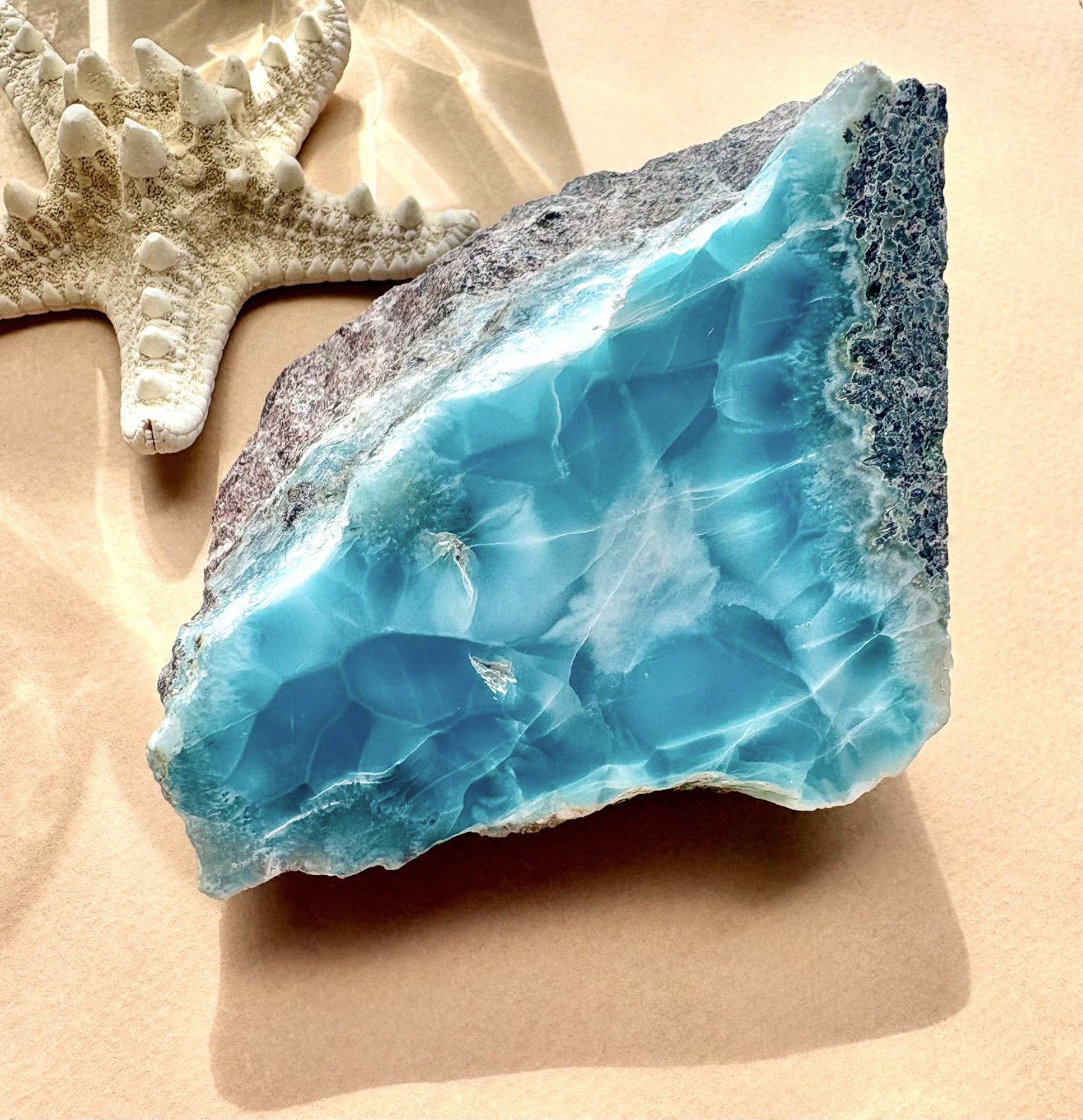 Collector-grade Larimar specimen showing polished blue face and natural matrix