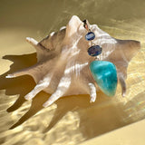 Larimar Blue Kyanite pendant styled on shell with ocean-blue gemstones