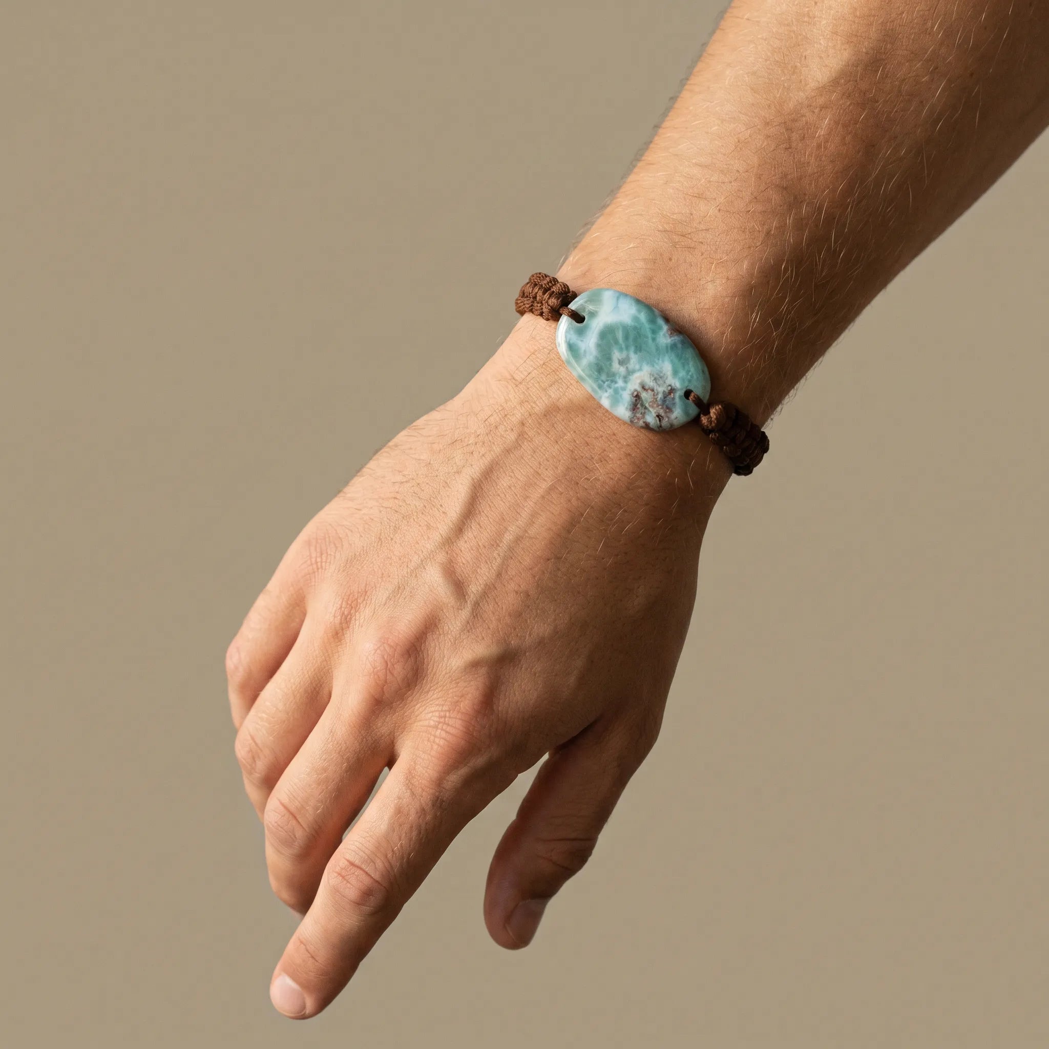Larimar cord bracelet worn on wrist with brown adjustable macramé design